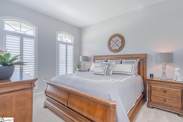 bedroom featuring light carpet