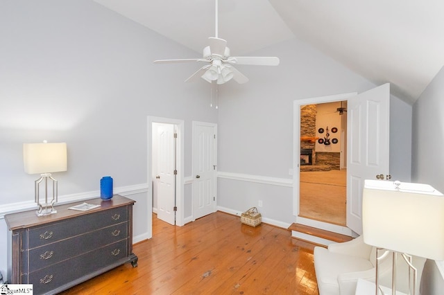 interior space with ceiling fan, light hardwood / wood-style floors, and lofted ceiling