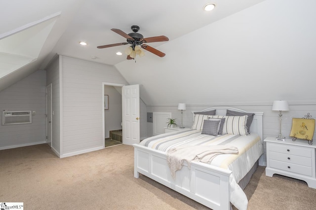 carpeted bedroom featuring vaulted ceiling, ceiling fan, wooden walls, and a wall unit AC