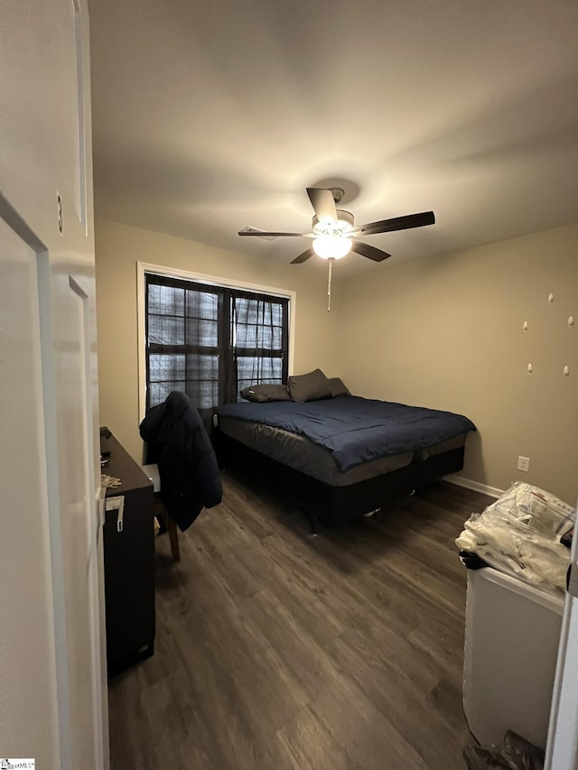 bedroom with ceiling fan and dark wood-type flooring