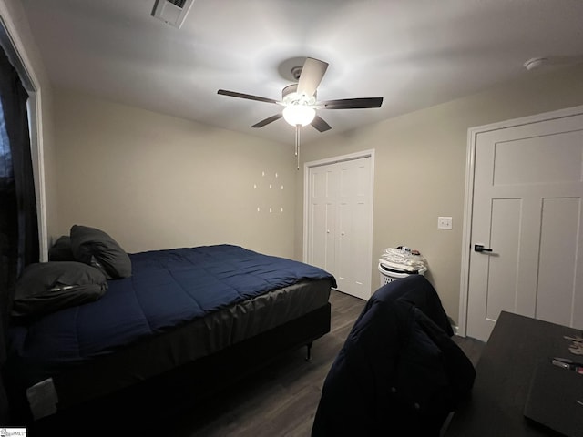 bedroom with ceiling fan, a closet, and dark wood-type flooring