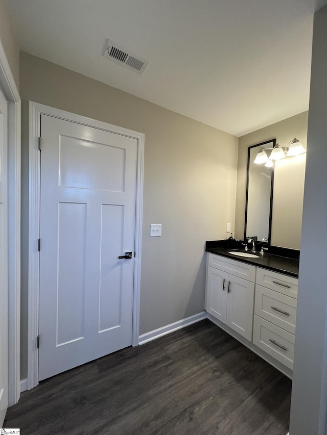 bathroom with hardwood / wood-style floors and vanity