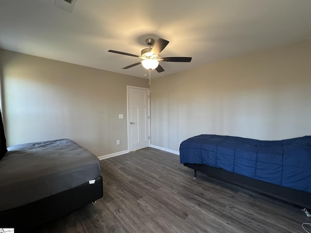 bedroom featuring ceiling fan and dark wood-type flooring