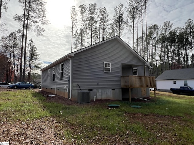 rear view of house with a yard and central AC unit