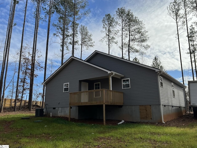 rear view of house featuring a yard and central air condition unit