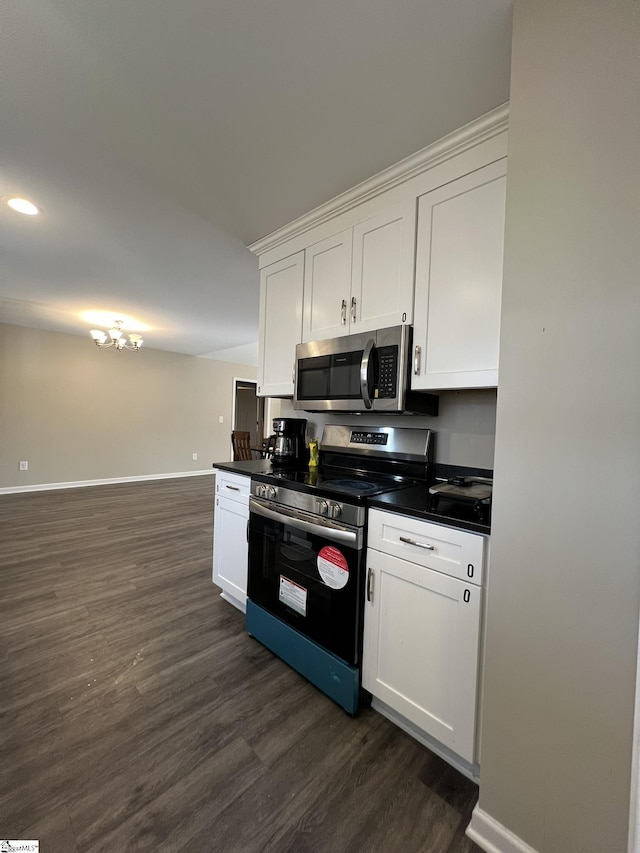 kitchen featuring appliances with stainless steel finishes, dark hardwood / wood-style flooring, and white cabinetry