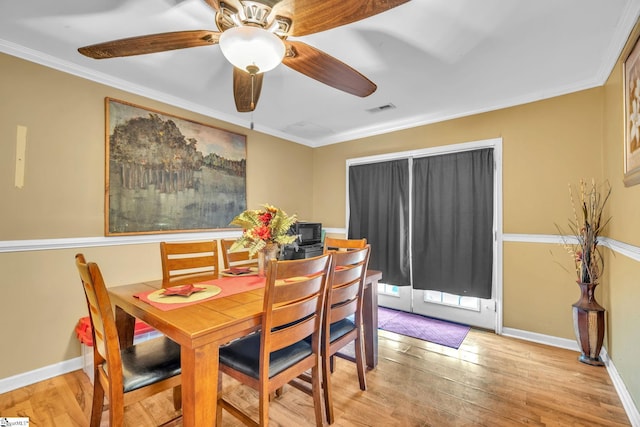 dining area featuring ceiling fan, ornamental molding, and light hardwood / wood-style flooring