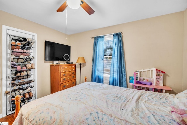 bedroom featuring ceiling fan and hardwood / wood-style flooring