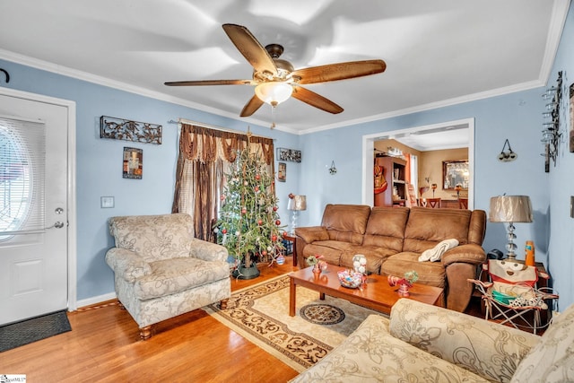 living room featuring hardwood / wood-style flooring, ceiling fan, and ornamental molding