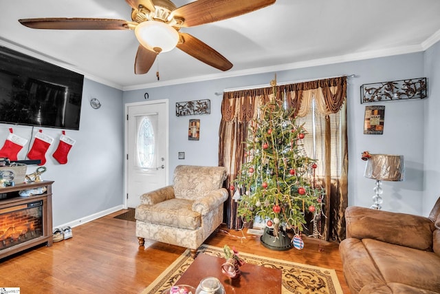 living room with hardwood / wood-style floors, plenty of natural light, and crown molding