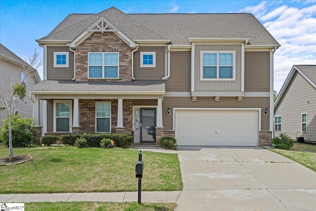 craftsman house featuring a front yard and a garage