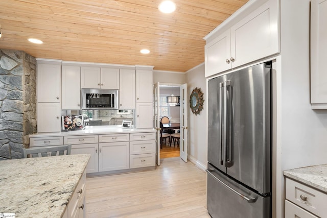 kitchen with light stone countertops, wooden ceiling, stainless steel appliances, and light hardwood / wood-style floors