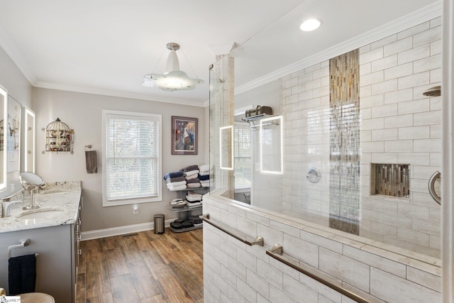 bathroom with vanity, crown molding, wood-type flooring, and an enclosed shower