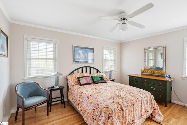 bedroom featuring ceiling fan, crown molding, multiple windows, and light hardwood / wood-style floors