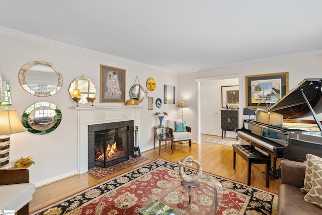 living room featuring a brick fireplace, ornamental molding, and wood-type flooring