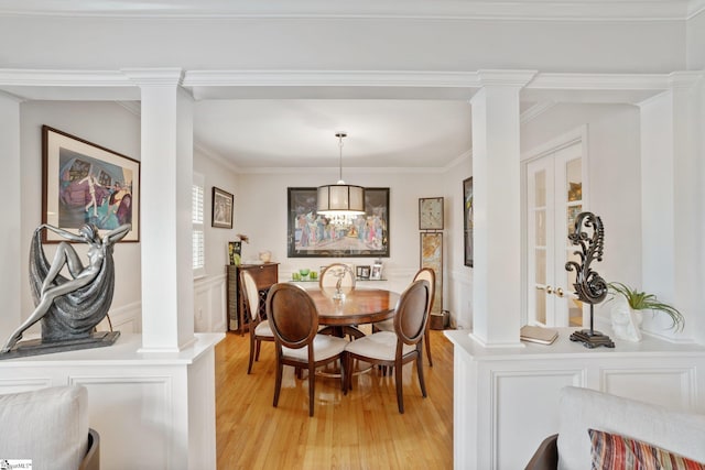 dining space featuring ornate columns and ornamental molding