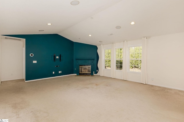 unfurnished living room with carpet and vaulted ceiling