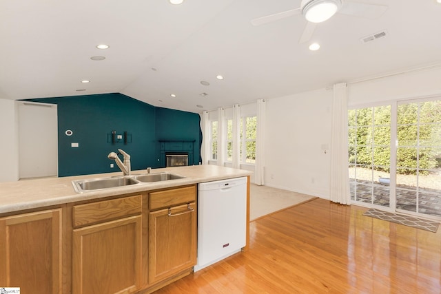 kitchen with dishwasher, plenty of natural light, sink, and vaulted ceiling