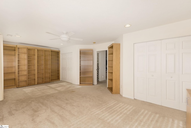 unfurnished bedroom featuring ceiling fan and light carpet