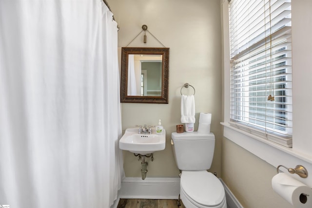 bathroom with hardwood / wood-style flooring, toilet, and sink