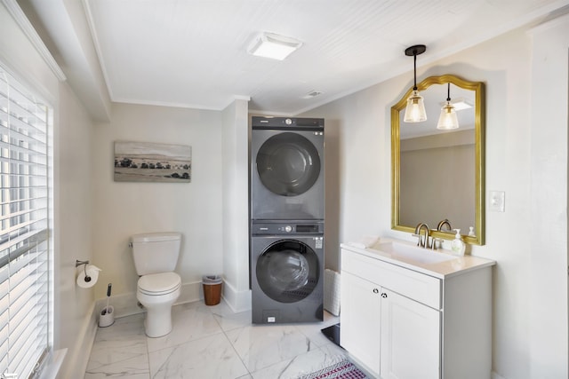 laundry room featuring crown molding, sink, and stacked washer and dryer