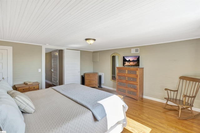 bedroom with hardwood / wood-style flooring and crown molding