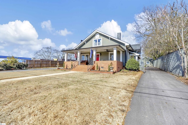 view of front of home with covered porch and a front yard