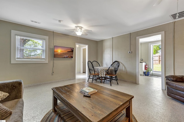 living room with ceiling fan and a healthy amount of sunlight