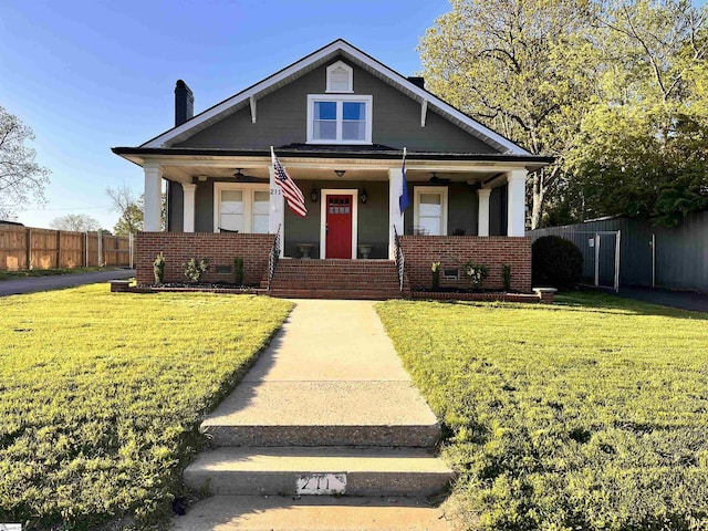 bungalow with a front lawn and covered porch