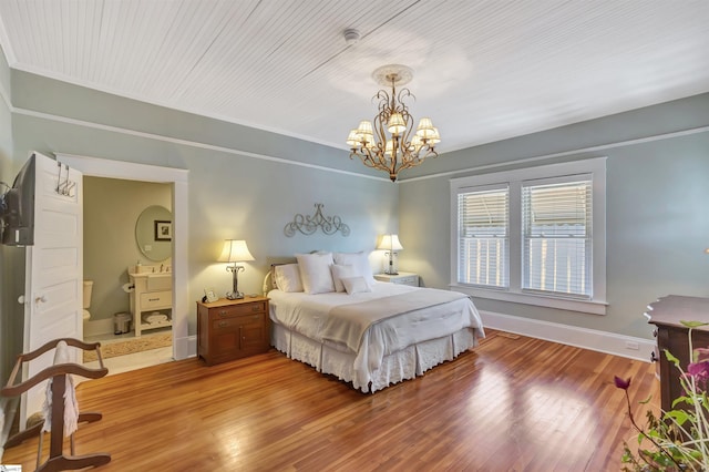 bedroom with a chandelier and hardwood / wood-style flooring