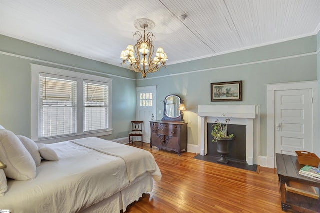 bedroom featuring wood-type flooring, crown molding, and a chandelier