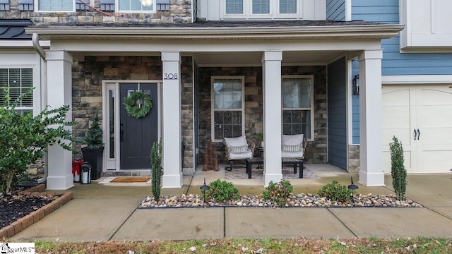 view of exterior entry with covered porch