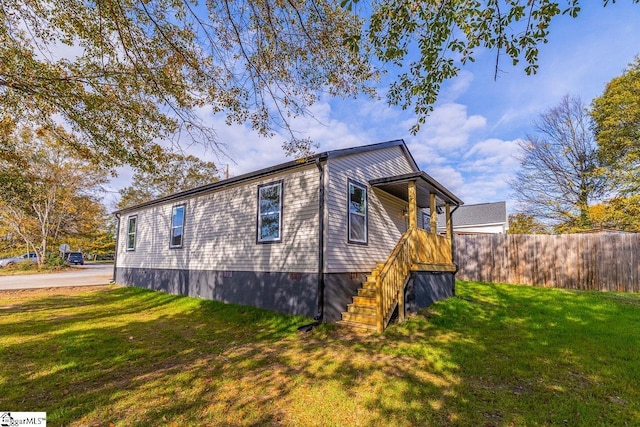 view of side of property with a lawn