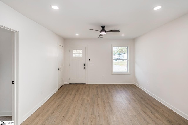 foyer with ceiling fan and light hardwood / wood-style floors