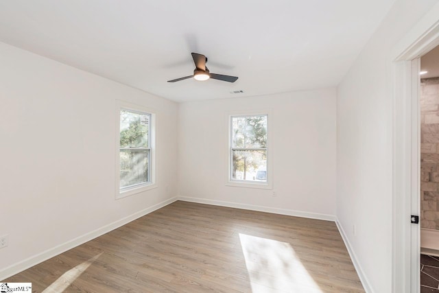 unfurnished room with light wood-type flooring, plenty of natural light, and ceiling fan