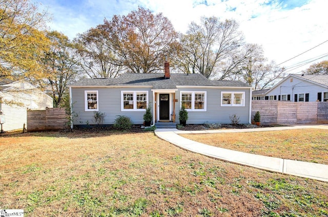 ranch-style home with a front lawn