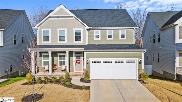 view of front facade featuring a front lawn, a porch, and a garage