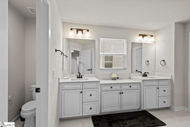 bathroom with tile patterned floors, vanity, and toilet