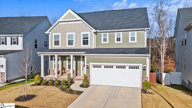 view of front of house with a front lawn, a porch, and a garage