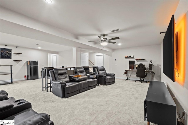 carpeted living room with ceiling fan