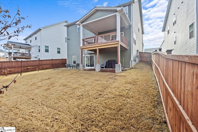 back of property featuring a yard and a balcony