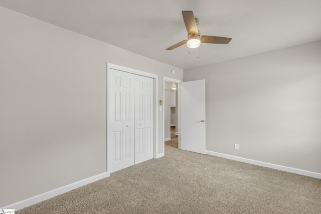 unfurnished bedroom with carpet, ceiling fan, and a closet