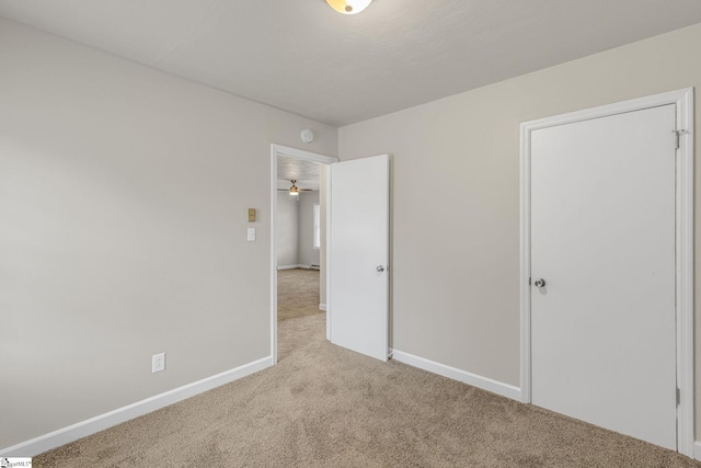 unfurnished bedroom featuring light carpet