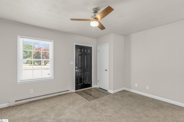 carpeted empty room with ceiling fan, ornamental molding, and a baseboard heating unit