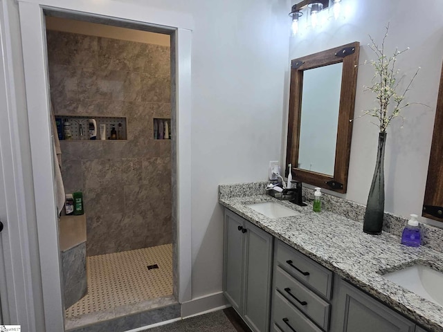 bathroom featuring a tile shower and vanity