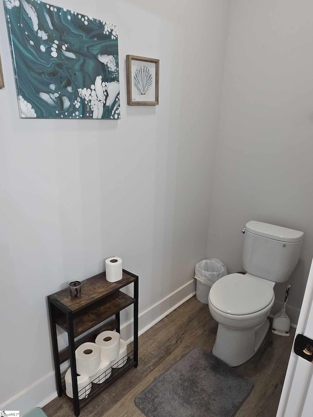 bathroom with toilet and wood-type flooring