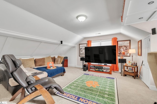 carpeted living room with lofted ceiling