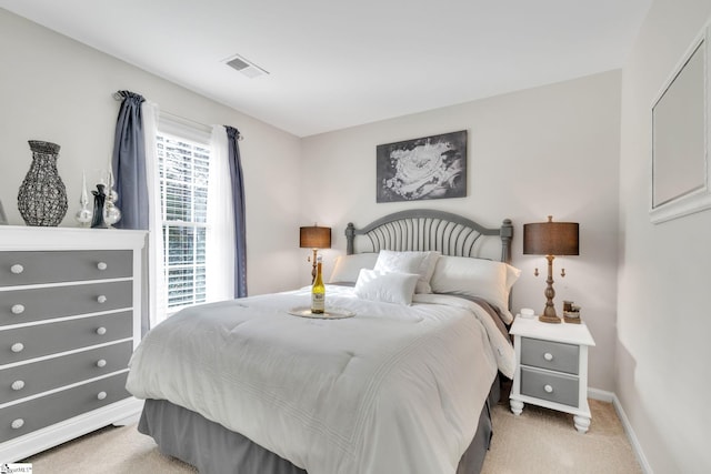 bedroom featuring light colored carpet