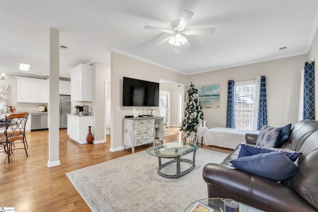 living room featuring light hardwood / wood-style flooring, ceiling fan, and ornamental molding