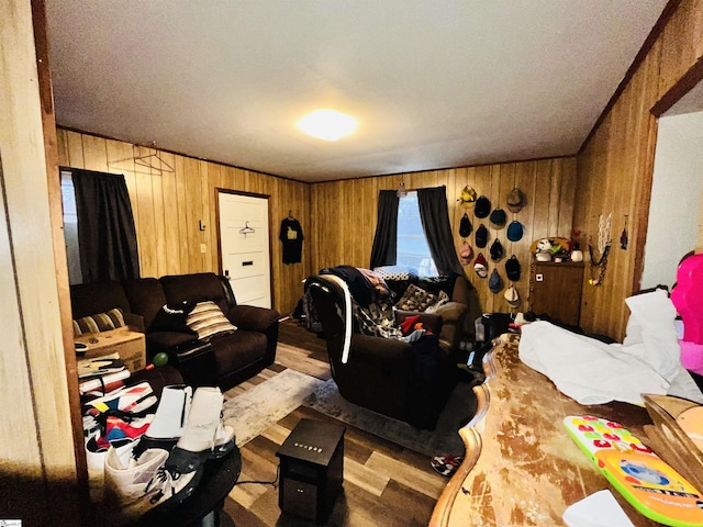 bedroom with light hardwood / wood-style floors and wooden walls